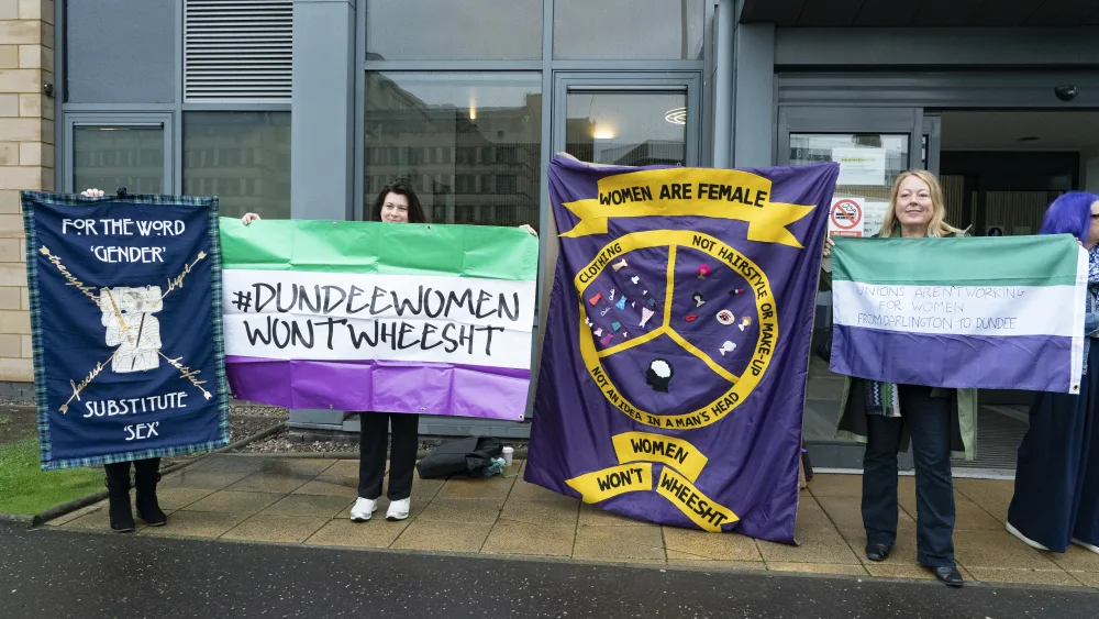 Women's rights campaigners holding placards and flags