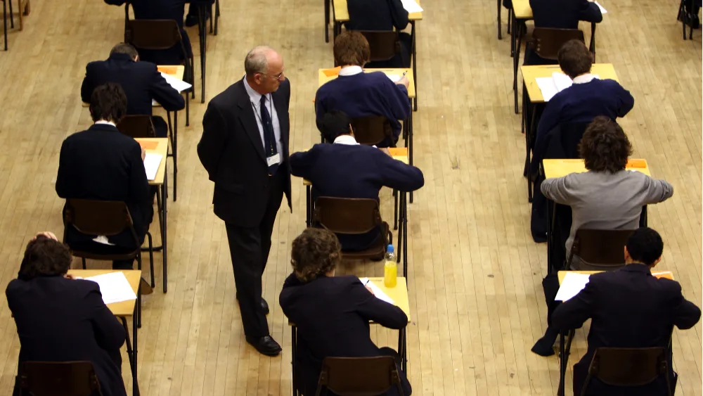 Pupils sitting an exam, with individual desks spaced out