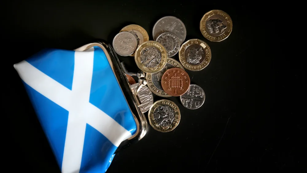 Coins spilling out of a Saltire purse