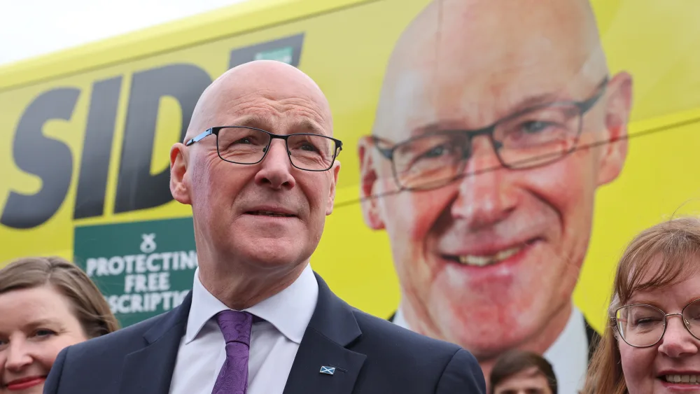 John Swinney in front of the SNP battlebus