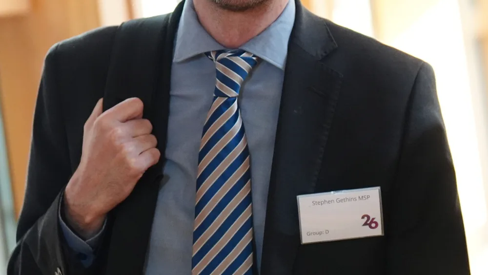 Stephen Gethins smiling while walking inside the Holyrood building