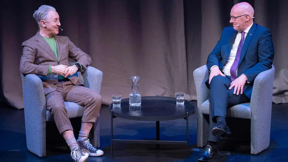 John Swinney chats to host Alan Cumming during an event in Edinburgh