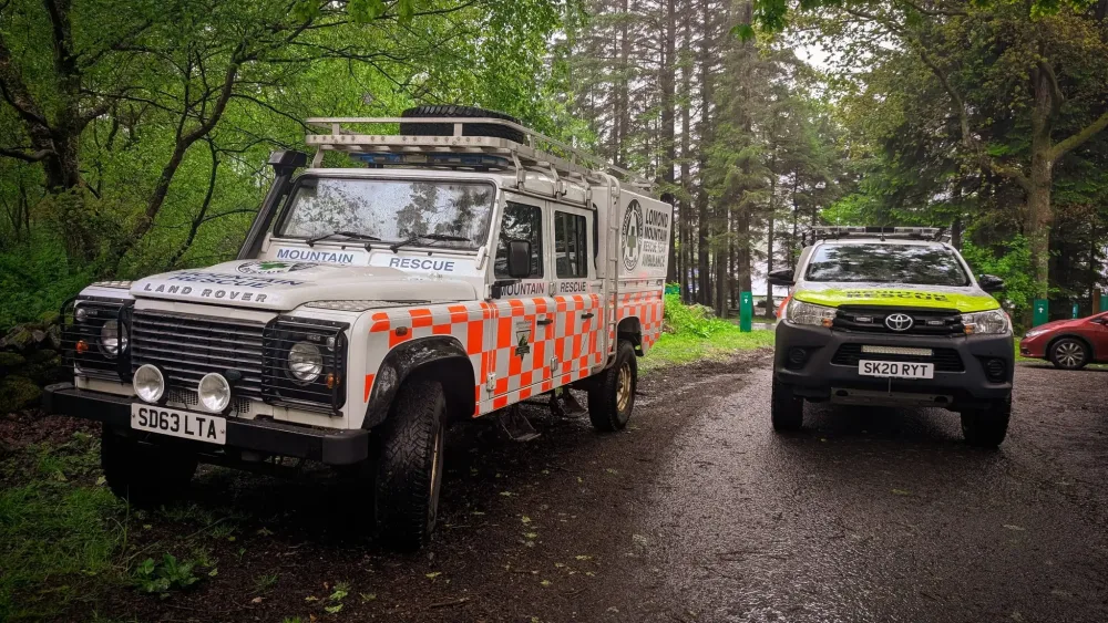 Picture of mountain rescue vehicles on a small road.