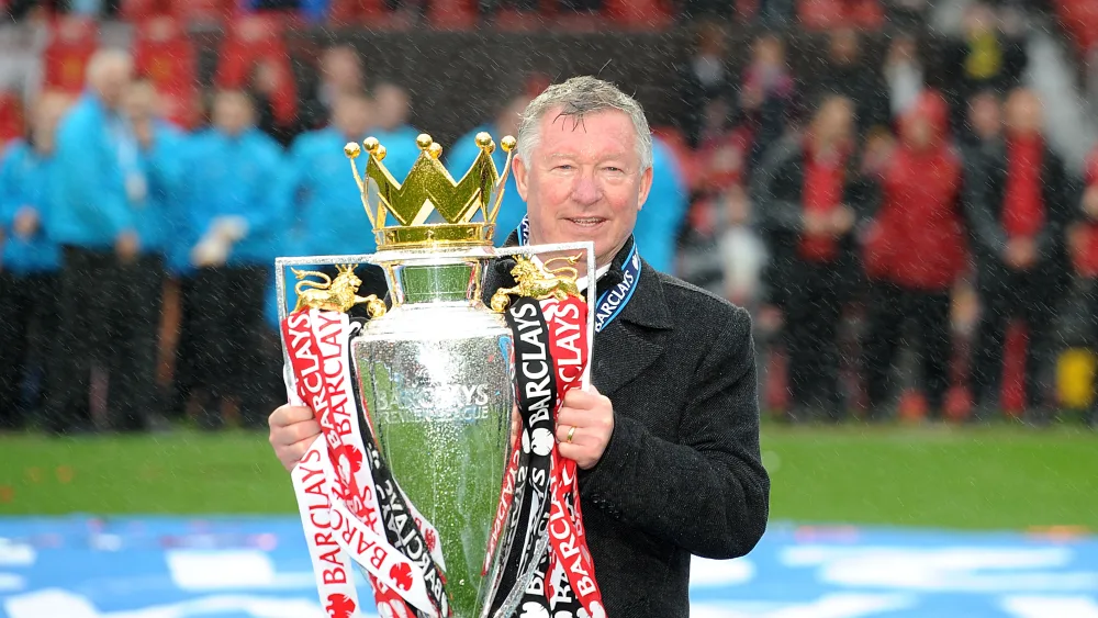 Sir Alex Ferguson celebrates with the Premier League trophy in May 2013