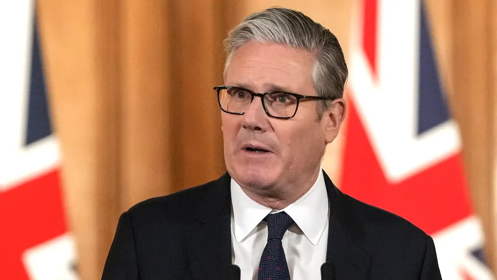 Sir Keir Starmer speaking in front of a Union flag