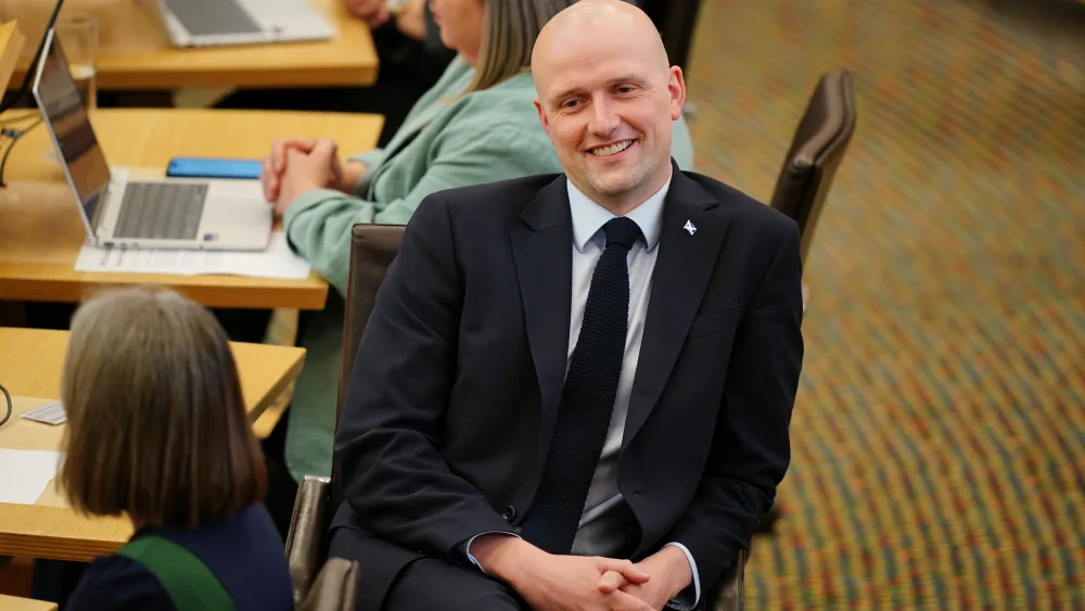 Stephen Flynn smiling while seated in Holyrood