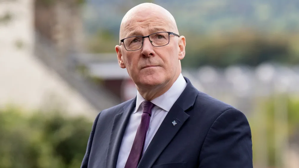 John Swinney listens to journalists