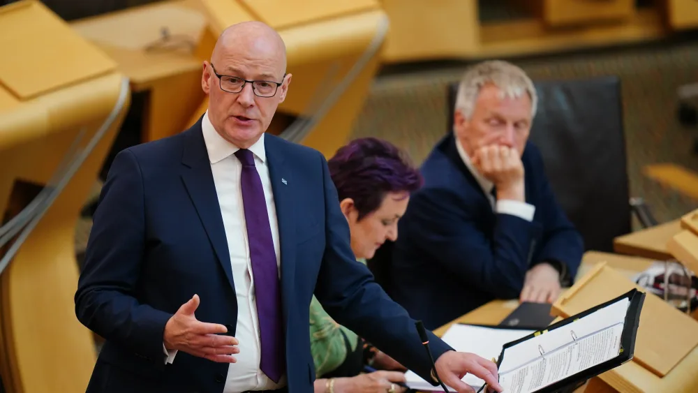 John Swinney standing while speaking in Holyrood