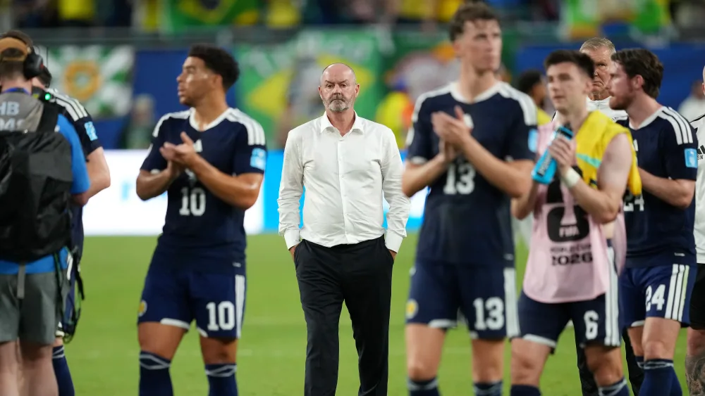 Scotland plays and Steve Clarke on the pitch after defeat to Brazil