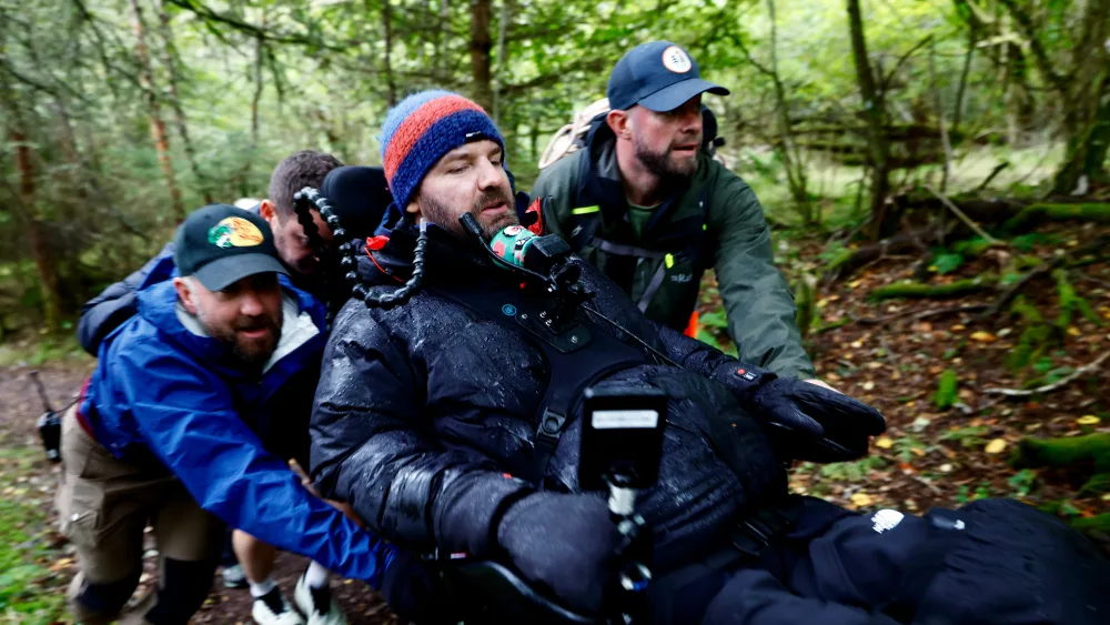 Danny Mavor in his wheelchair with supporters during his coast-to-coast challenge