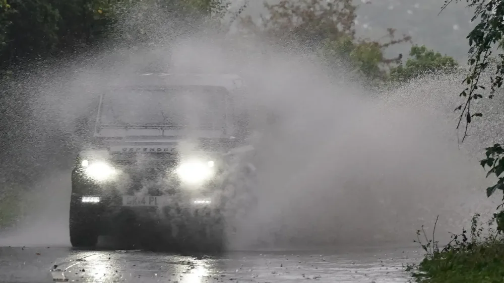 Car driving in heavy rain