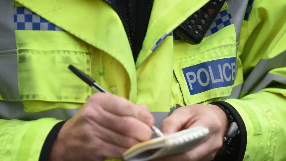 Police officer writes in notebook