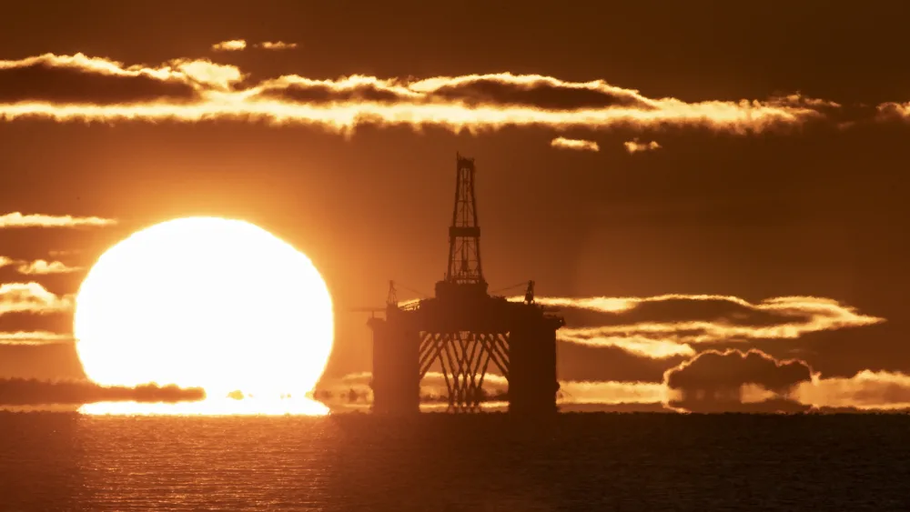 A sunset behind an oil rig