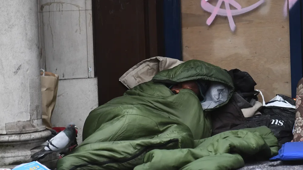 A homeless person sleeping in the street