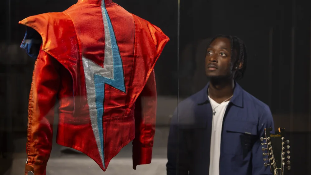 A person looks at a David Bowie jacket