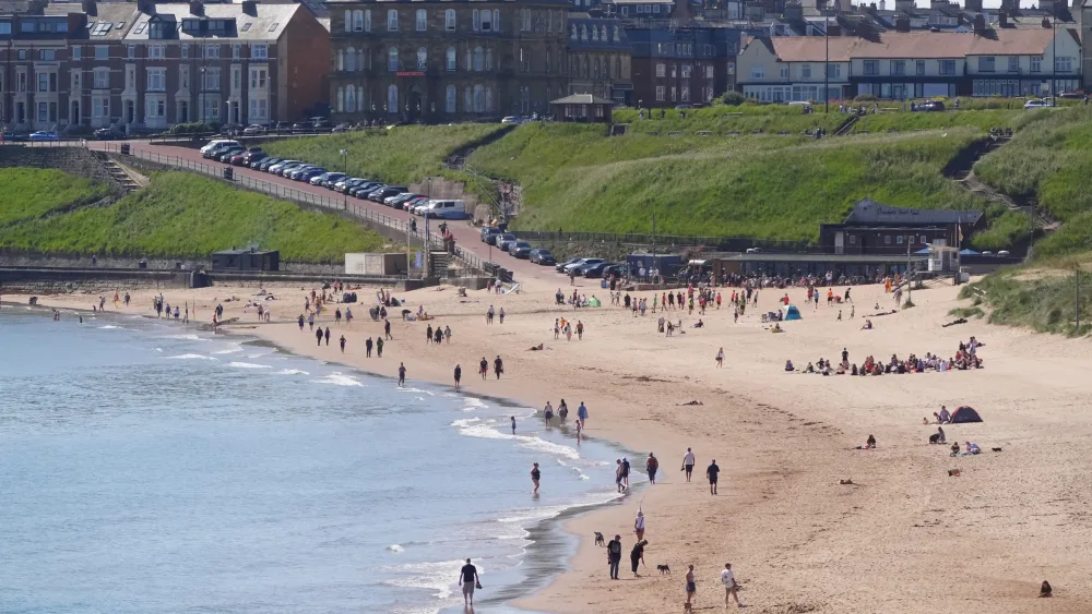 People on Tynemouth beach in the north-east of England